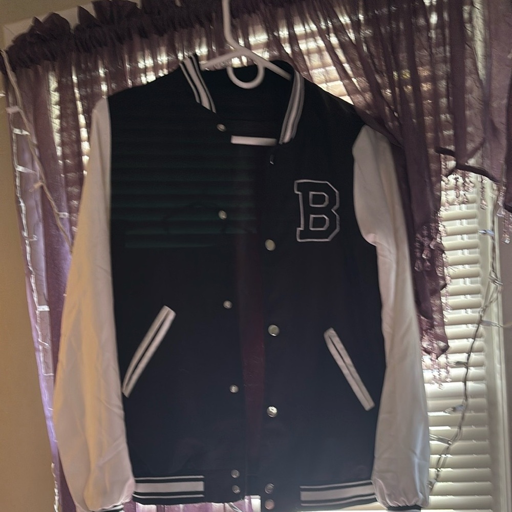 Stylish black and white varsity jacket with a bold 'B’